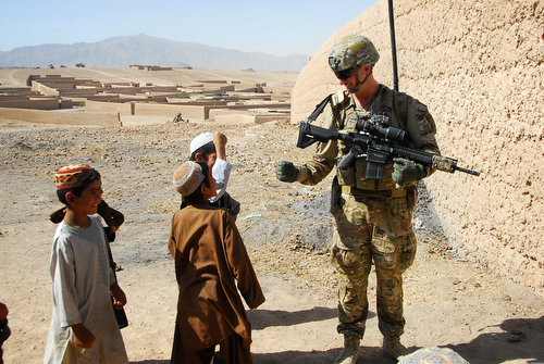 Australian Army Pvt. Levi Mooney, right, bumps fists with a child during a patrol in Tarin Kowt, Uruzgan province, Afghanistan, July 26, 2013. (U.S. Army National Guard photo by Sgt. Jessi Ann McCormick/Released)