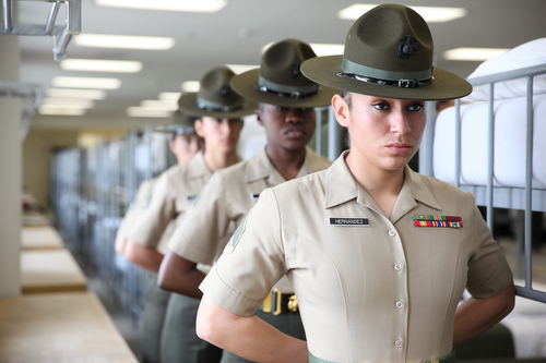 U.S. Marine drill instructors with 4th Recruit Training Battalion, Recruit Training Regiment, Marine Corps Recruit Depot Parris Island stand at parade rest as they wait to give a demonstration of what recruits encounter during pick-up week, the first week of recruit training, during the 70th anniversary of women in the Marine Corps aboard Marine Corps Recruit Depot Parris Island, S.C., March 1, 2013. The celebration was in acknowledgement of the seventy years of continuous service by women in the Marine Corps. (U.S. Marine Corps photo by Cpl Aneshea S. Yee/Released)
